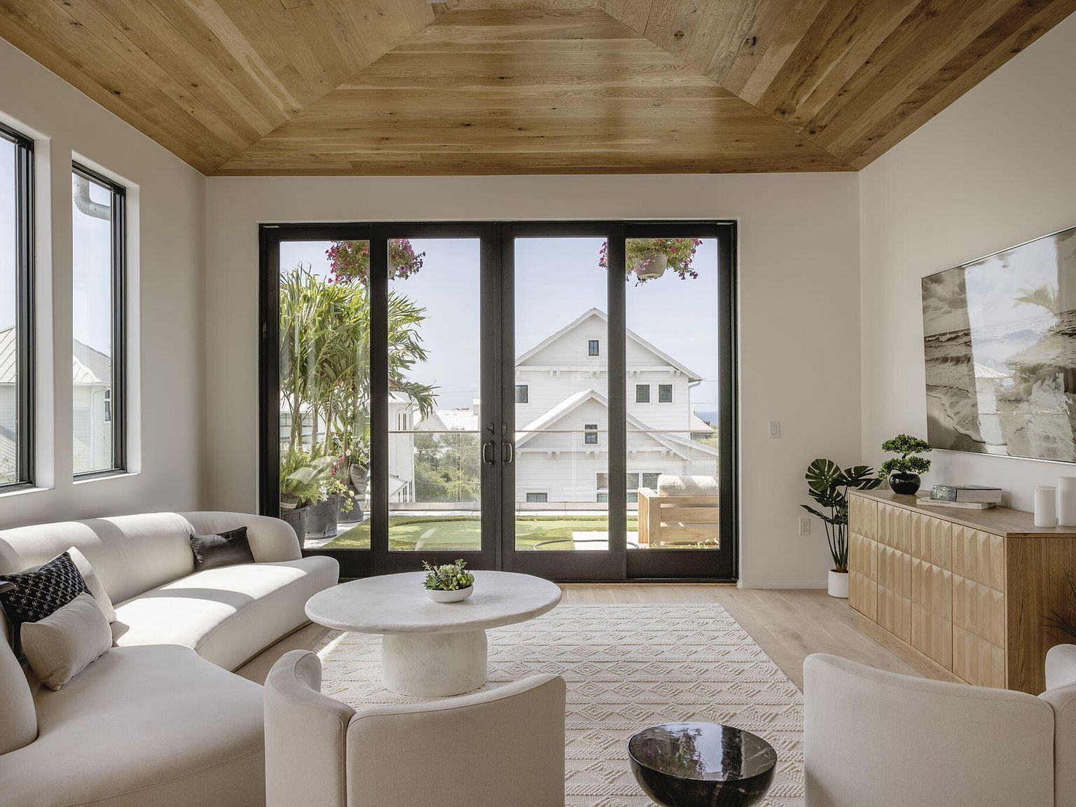 Den with vaulted wood ceiling